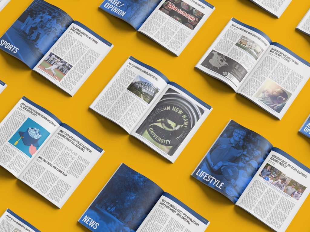 Multiple issues of the Penmen Press opened and laid out on a yellow table.